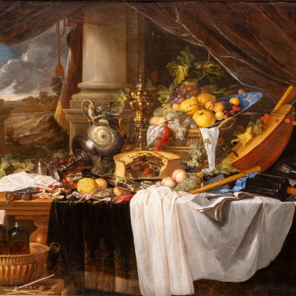 A large still-life painting by Dutch artist Jan Davidsz de Heem. A table heaving with a display of textiles, foods, instruments and decorative objects.